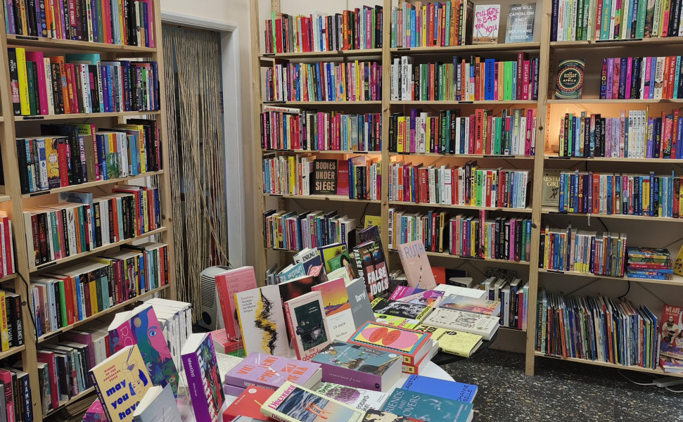 Books on bookshelves and also displayed on tables