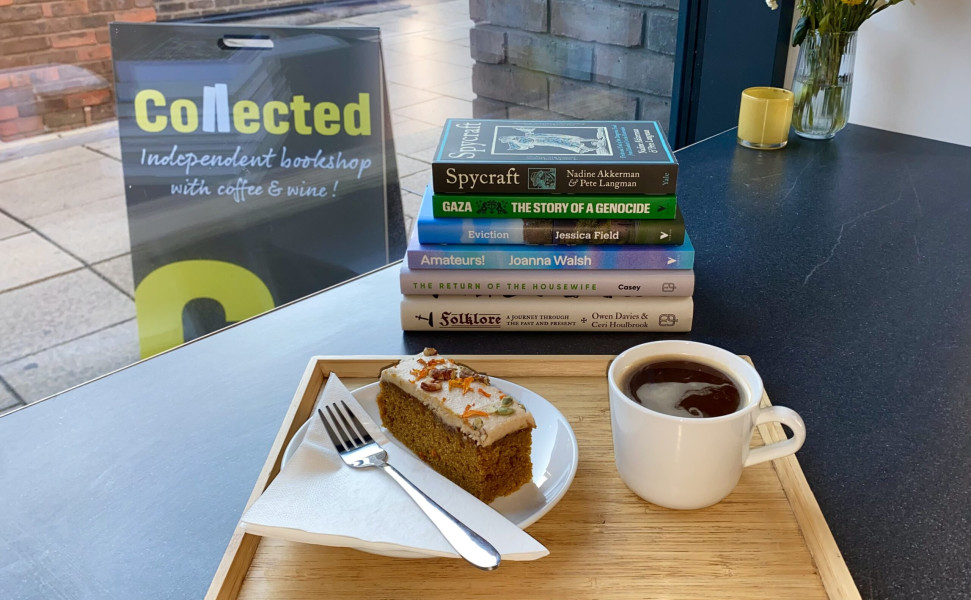 Image of a cup of coffee, piece of cake and books