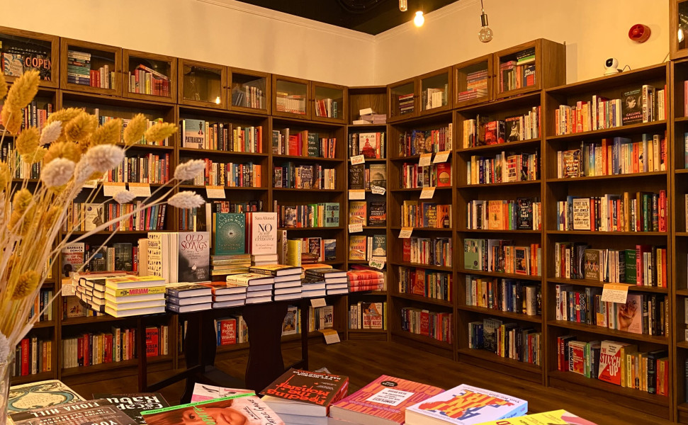 Inside of shop showing bookshelves and books on display tables