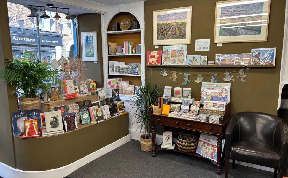 Inside of the shop showing book displays and an armchair