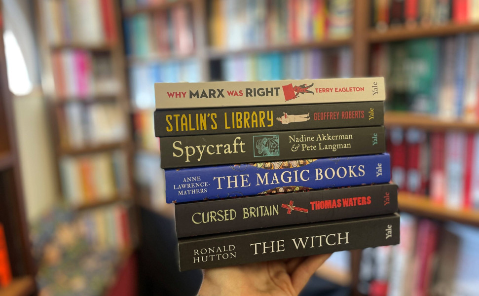 Six books on display held by hand